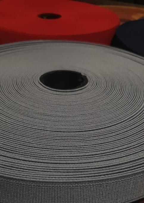 Close-up of grey loom elastic roll showing the woven texture